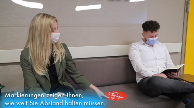 The safety distance is marked by notices on the couch