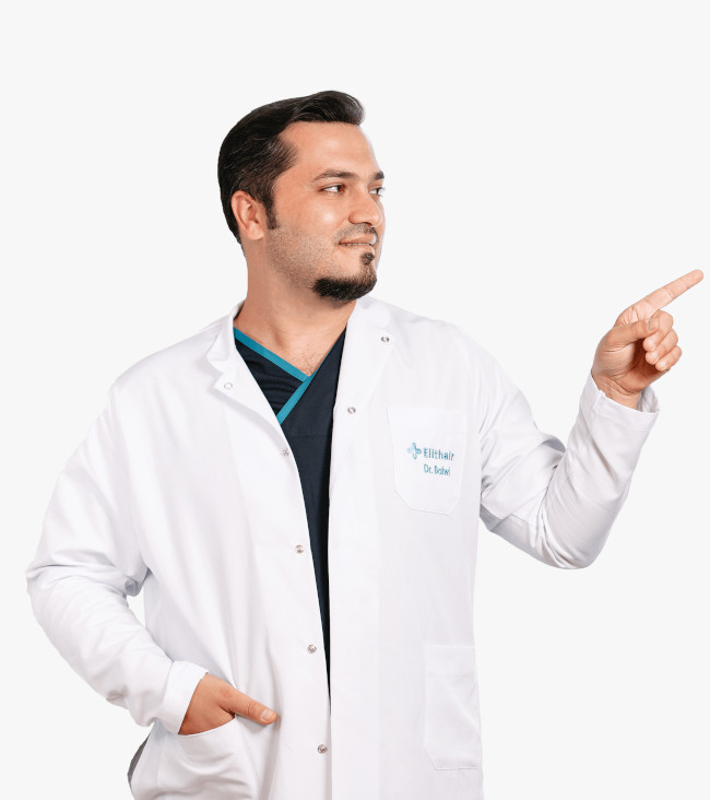 Dr. Balwi zeigt mit dem Finger zur Seite