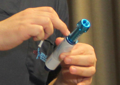 A hair transplant surgeon preparing the local anaesthetic
