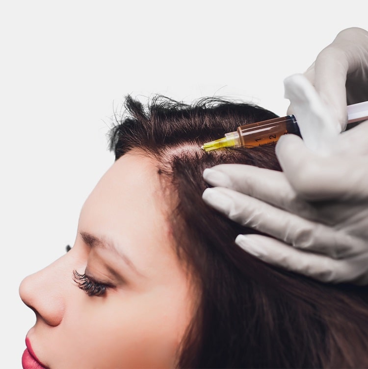 Woman receiving an injection before hair restoration treatment