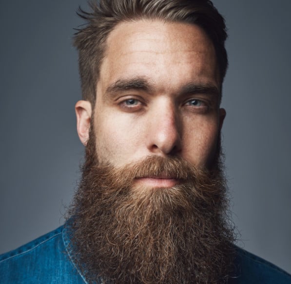 man with a thick beard looking into the camera