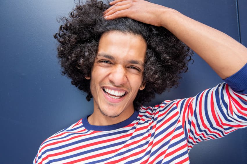 Man with curly hair after having a hair transplant